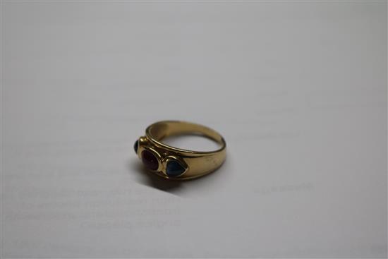A yellow metal, cabochon ruby and sapphire three stone dress ring, size R.
